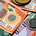 **Thai Baht notes and coins:** A close-up shot showcasing various denominations of Thai Baht banknotes (20, 50, 100, 500, 1000) and coins (1, 2, 5, 10), emphasizing their colors and markings for easy identification.